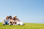 Happy Family Relaxing In Garden Stock Photo