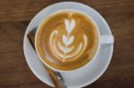 Coffee With Latte Art On Wooden Table Stock Photo