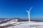 Wind Turbine And Blue Sky In Winter Landscape Stock Photo