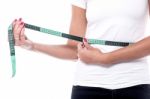 Woman Measuring Waist With An Inch Tape Stock Photo