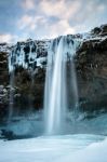 View Of Seljalandfoss Waterfall In Winter Stock Photo