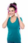 Cheerful Girl Listening To Music Stock Photo