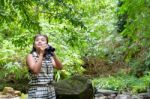 Girl Using Binoculars In Forest Stock Photo