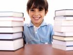 School Boy Surrounded By Books Stock Photo