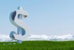 Damaged Concrete Dollar Sign Statue Isolated On Grass Meadow With Snowy Mountain And Blue Sky As Background Stock Photo