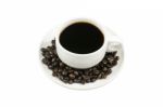 White Cup Of Coffee On Beans Stock Photo