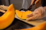 Cutting Japanese Melon Stock Photo