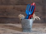 Galvanized Can With Trowel And Shovel On Grunge Wood Background Stock Photo