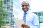 Smiling Man Using Tablet Pc At Outdoors Stock Photo