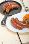 Beef Sausages Cooked On Iron Skillet Stock Photo