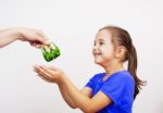 Mother Giving The Purse To A Little Girl Stock Photo