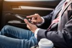 Young Handsome Businessman Working In Back Of Car And Using A Ta Stock Photo