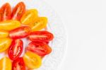 Cherry Tomatoes On White Plate Stock Photo