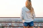 Beautiful Blonde Stands On The Edge Of The Roof Stock Photo