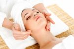 Woman Getting Facial Massage In Spa Salon Stock Photo