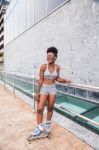 Young African Woman Riding On Skates Stock Photo