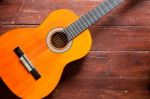 Flamenco Guitar On Wood Background Illuminated By Natural Daylight Stock Photo