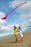 Couple Flying Kite Stock Photo