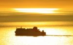 Ferry At Sunset Stock Photo