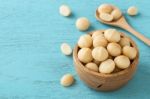 Macadamia On Blue Table Background Stock Photo