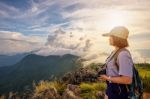 Girl Tourist On Mountains At Sunset Stock Photo