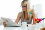 Beautiful Young Woman Enjoying Breakfast In The Kitchen Stock Photo