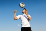 Football Player Striking The Ball At The Stadium Stock Photo