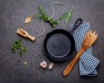 Empty Old Cast Iron Skille On Dark Stone Background. Ingredients Stock Photo