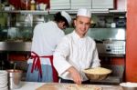 Young Chef Making Pizza At Kitchen Stock Photo