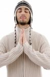 Young Guy Praying With woolly hat Stock Photo