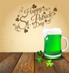 Green Beer With Shamrock On Wooden Floor Stock Photo