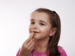 Cheerful Girl Paints Lips Stock Photo