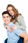 Girlfriend Enjoying Piggyback Ride Stock Photo