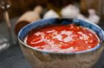 Pureed Tomatoes In A Ceramic Dish On A Table Stock Photo