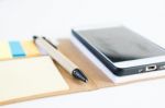 Mobile Phone Notebook And Pen On White Background Stock Photo