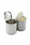 Empty Opened In Front Of Full Closed Sweet Milk Tin Can Stock Photo