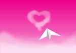 Paper Plane Flying In The Pink Sky Stock Photo