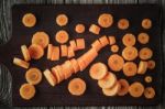 Sliced Carrots On The Wooden Board Top View Stock Photo