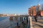 People Relaxing By The River Thames Stock Photo