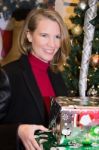 Blonde Female In Christmas Scene Holding Gifts Stock Photo