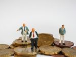 Miniature Businessman Stand On Euro Coins And Book Bank. Busines Stock Photo