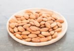 Almond Nuts On Wooden Plate Stock Photo