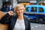 Cheerful Business Woman Holding Shopping Bag Stock Photo