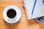 Hot Cup Of Coffee On Working Table Stock Photo