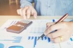 Businessman's Hands With Calculator At The Office And Financial Stock Photo