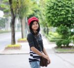 Sweet Young Woman Standing Outdoors And Smiling In Public Park Stock Photo