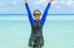 Happy Asian Teen Girl Play Splashing Water In The Sea Stock Photo