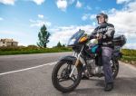 Elderly Motorcyclist Wearing A Jacket And Glasses With A Helmet Stock Photo