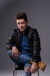 Casual Young Man In Black Leather Jacket And Denim Jeans Stock Photo