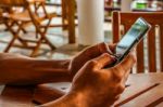 Close Up Photo Of Hands Using Mobile Smartphone Stock Photo